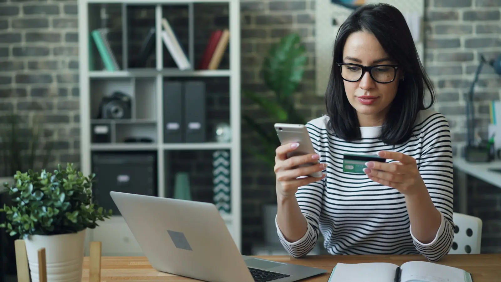 A shopper researching a purchase on her phone before paying
